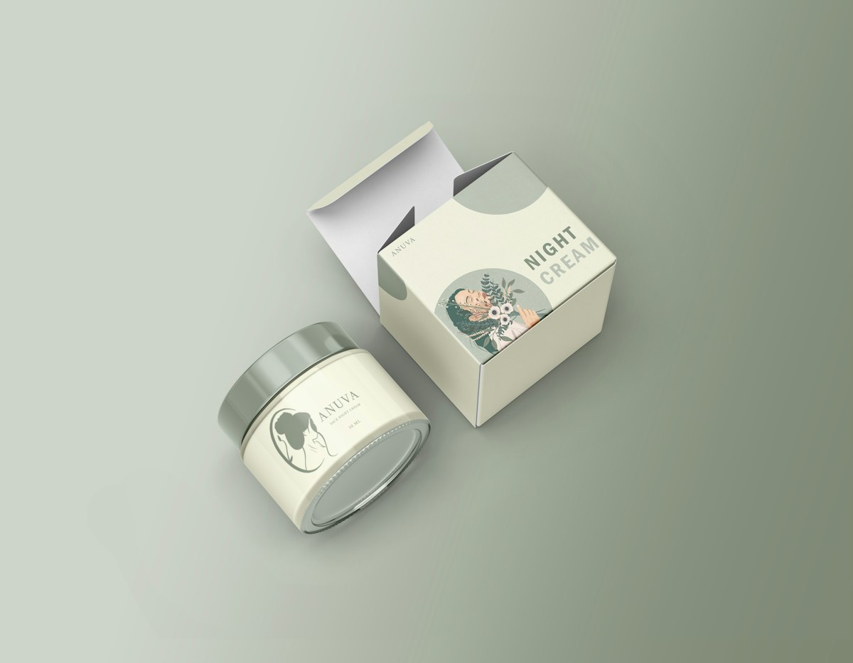 Skincare jar next to a printed product box